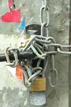 Old padlock with many chains protected door Stock Photos