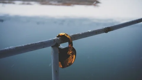 Old padlock on the railing of the bridge close-up Stock Footage 99591455
