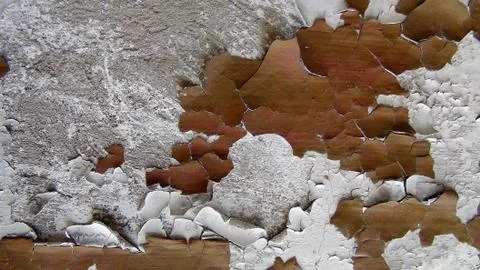 Old paint on a concrete wall that has cracked cubes and falls off Stock Photos