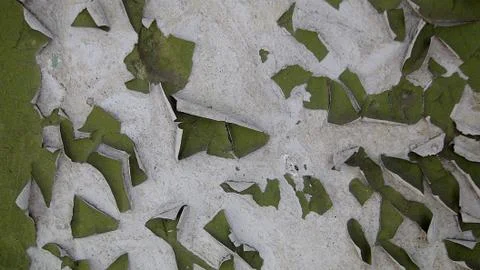 Old paint on a concrete wall that has cracked cubes and falls off Stock Photos