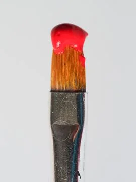 Old paintbrush with red paint Stock Photos