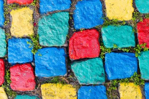 Old painted cobblestone background with grass Stock Photos