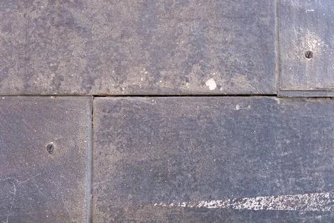 Old painted grey plaster tile wall texture, textured concrete gray surface. 写真素材