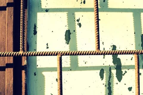 Old painted window behind a rusty bars on a sunny day. Abstract background Foto stock