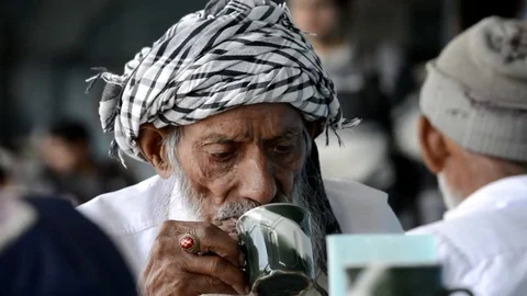 Old Pakistani Man Drinking Tea Stock Footage