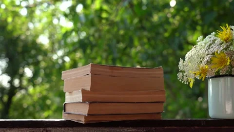 Old paper books stack on wooden vintage background outdoor isolated on green Stock Footage 136951049