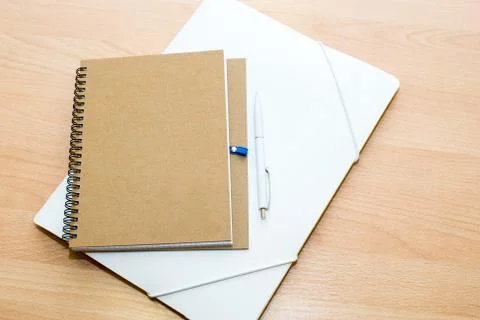 Old paper folder with white label closed on a white wooden background Foto stock