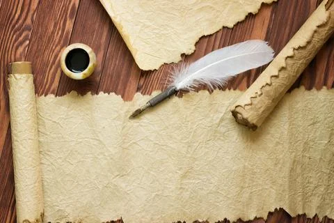 Old paper, scroll and quill pen on wooden paper with copy space Stock Photos