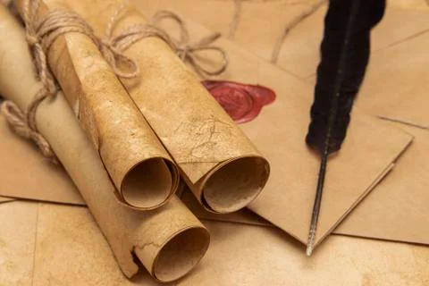 Old paper scrolls, pen for writing. Envelope sealed with a seal and jute crep Stock Photos
