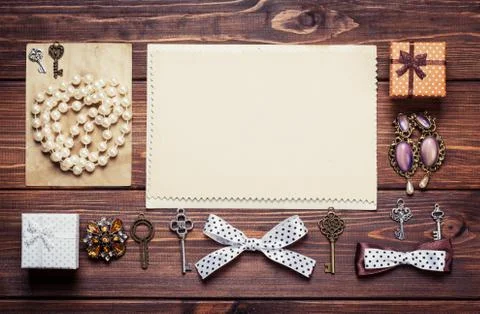 Old paper sheets surrounded by retro objects on wooden background Stock Photos