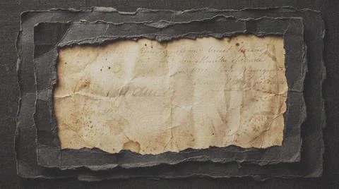 Old parchment on dark slate background. Fotos Stock