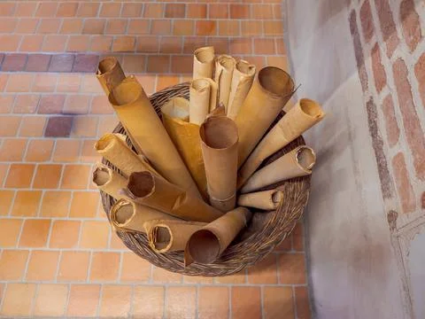 Old parchment scrolls in a wicker bask Stock Photos
