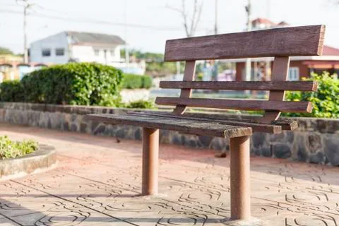 Old park bench on the sidewalk. Stock Photos