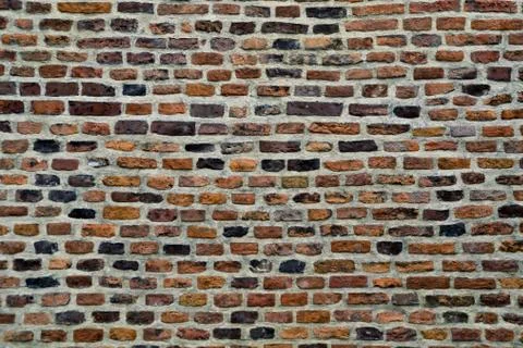 Old parti-colored brick wall Stock Photos