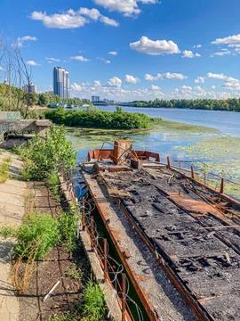 An old, partially submerged dilapidated structure with rusted metal elements  Foto stock