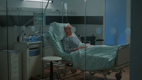 Old patient with breathing problems sitting in hospital ward Stock Footage 157063890