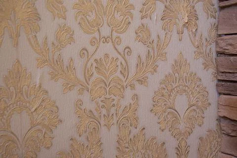 Old patterns on the wall. Old wallpaper. Home decoration. Stock Photos