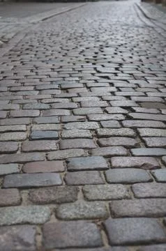 Old pavement lined with stone, stone pavement background close-up. Stock Photos
