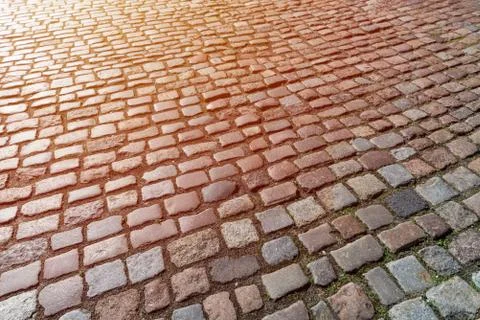 Old paving stones pattern. Texture of ancient german cobblestone in city down Stock Photos