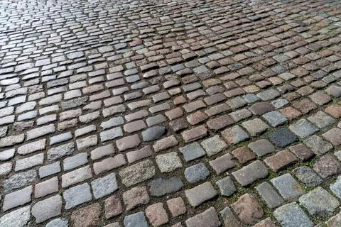 Old paving stones pattern. Texture of ancient german cobblestone in city down Stock Photos
