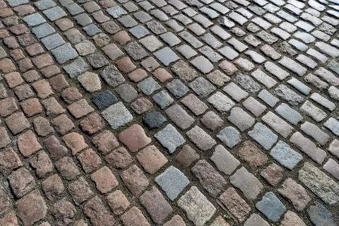 Old paving stones pattern. Texture of ancient german cobblestone in city down Foto stock