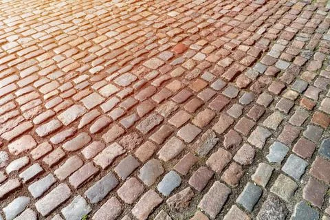 Old paving stones pattern. Texture of ancient german cobblestone in city down Foto stock