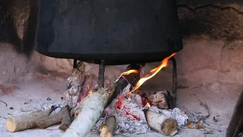 Old peasant woman preparing bread and pastries over a wood fire Stock Footage 292852271
