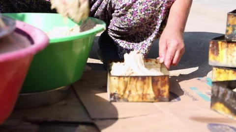 Old peasant woman preparing bread and pastries over a wood fire Stock Footage 292852293