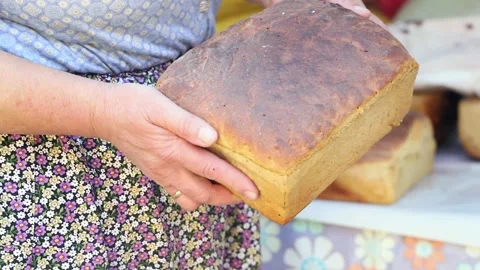 Old peasant woman preparing bread and pastries over a wood fire Stock Footage 292852366