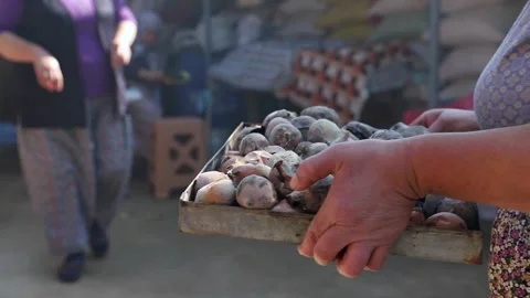 Old peasant woman preparing bread and pastries over a wood fire Stock Footage 292852385