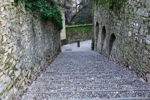 Old pedestrian street as a down from the Upper Bergamo to the Lower Bergamo. Stock Photos