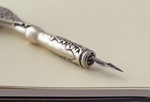 Old pen over notebook Stock Photos