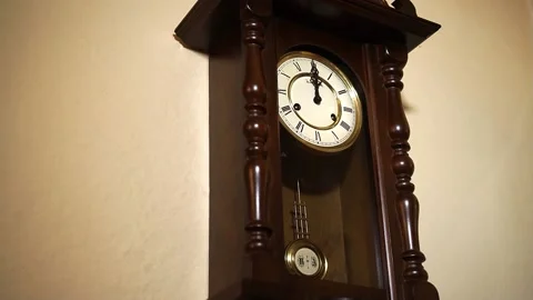 Old pendulum clock timelapse 5 to 12 oblique view from below .. Stock Footage 167655253