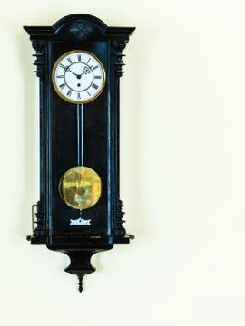 Old pendulum clock on wall Stock Photos