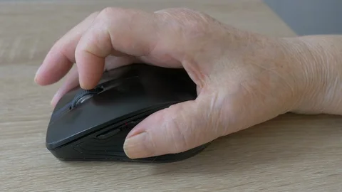 Old people and computer. Senior woman is holding computer mouse. Stock Footage 125404104