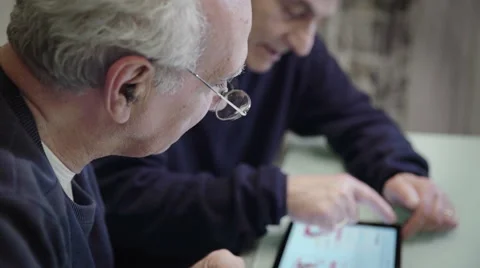 Old people and technology: two friends using tablet Stock Footage 63418966