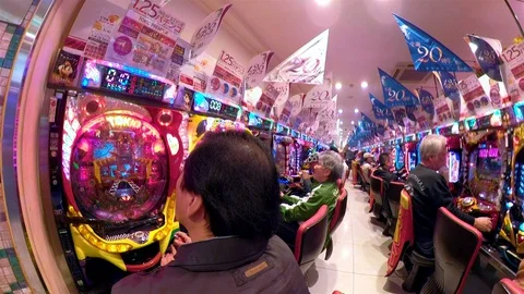 Old people playing on the arcade games in Osaka Japan Stock Footage 129277005