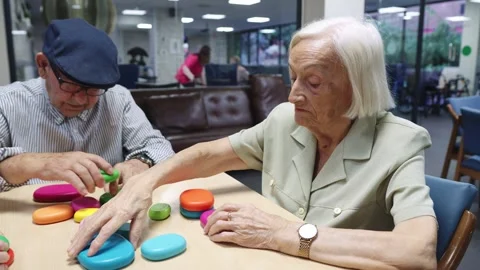 Old people resolving brain skill games in a nursing home Stock Footage 254905005
