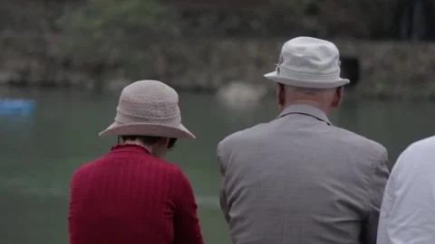 Old People sitting in front of river - Kyoto, Japan Stock Footage 150325260