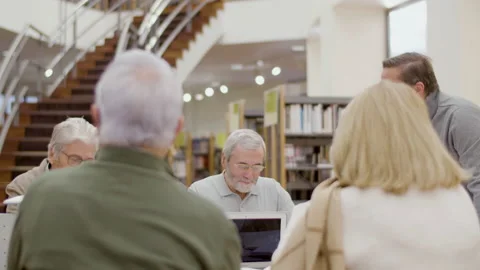 Old people talking with teacher during class in library Stock-Footage 232622688