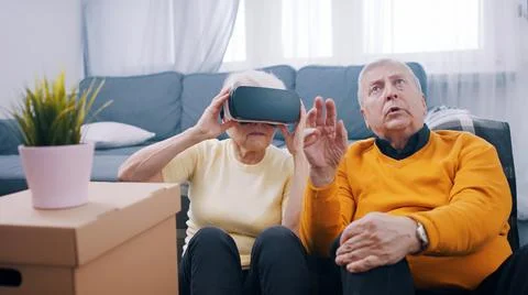 Old people using new headset goggles trends technology Stock Photos
