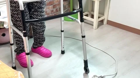 Old people's feet using walking aids, slow motion Video stock 263402297