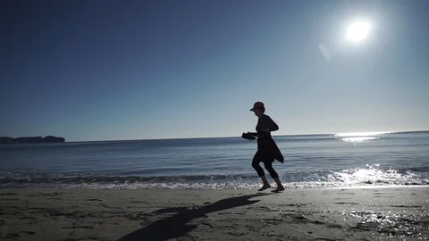 Old person jog on beach Stock Footage 89693256