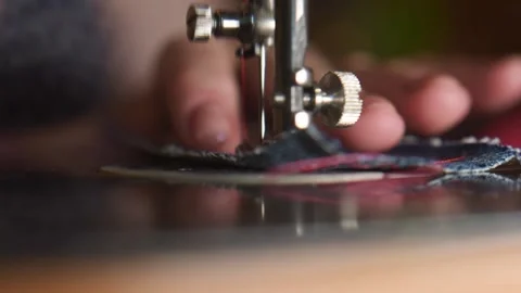 Old person sewing with a sewing machine. Close up. Slow motion. Stock Footage 134963889