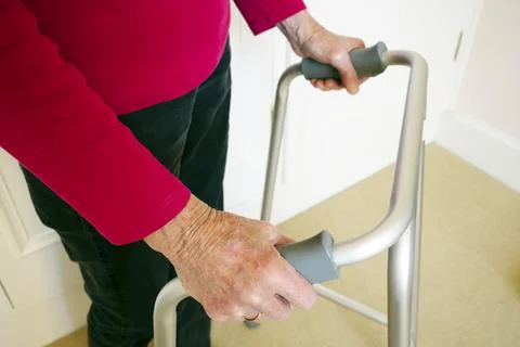 Old person with walking frame inside house Stock Photos