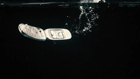 Old phone falling into the water 스톡 동영상 130308133
