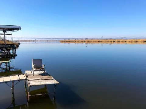 Old pier on the river. Stock Photos