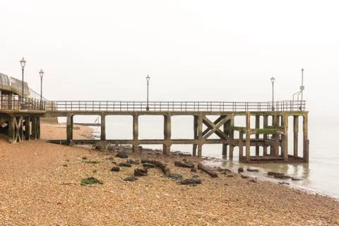Old pier with a view of a beach Stock Photos