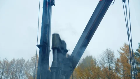 The old pile driver with hammer clog ram work. Building the house foundation. Stock Footage 129102343
