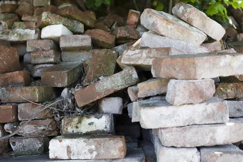 Old piles of bricks at  construction site Stock Photos
